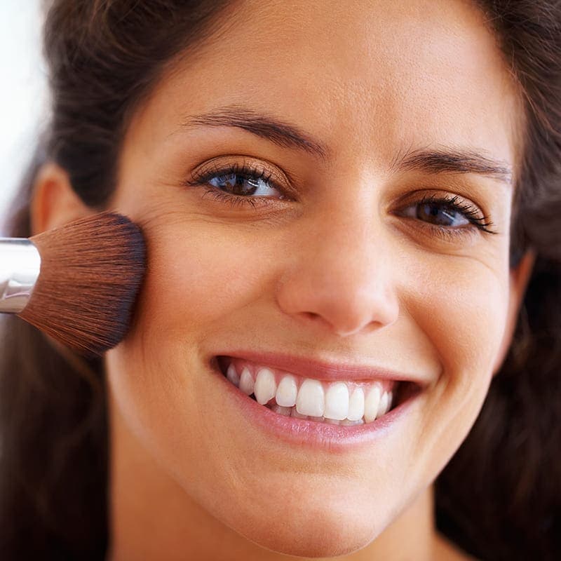 Woman applying makeup